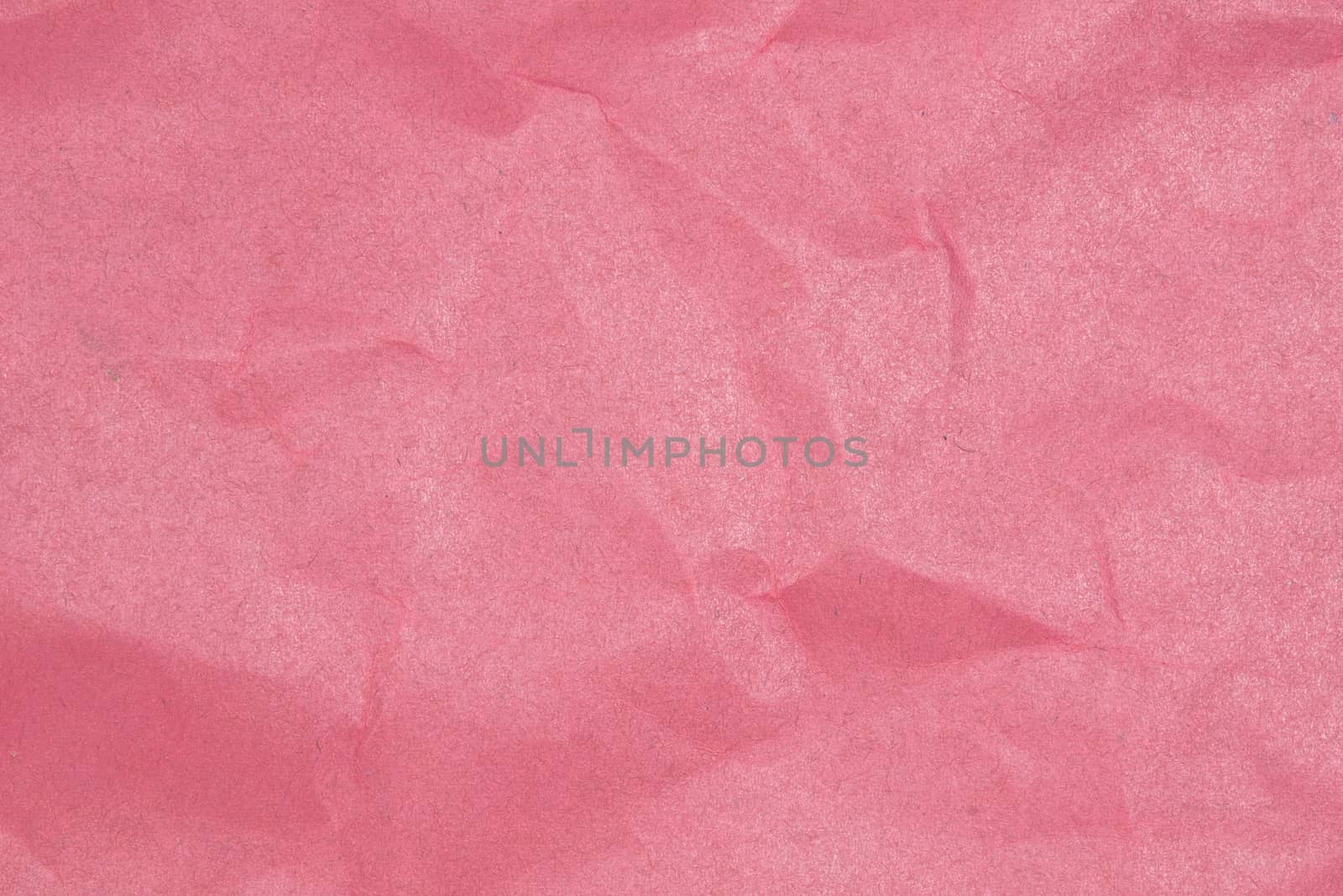 Crumpled paper texture - pink paper sheet.