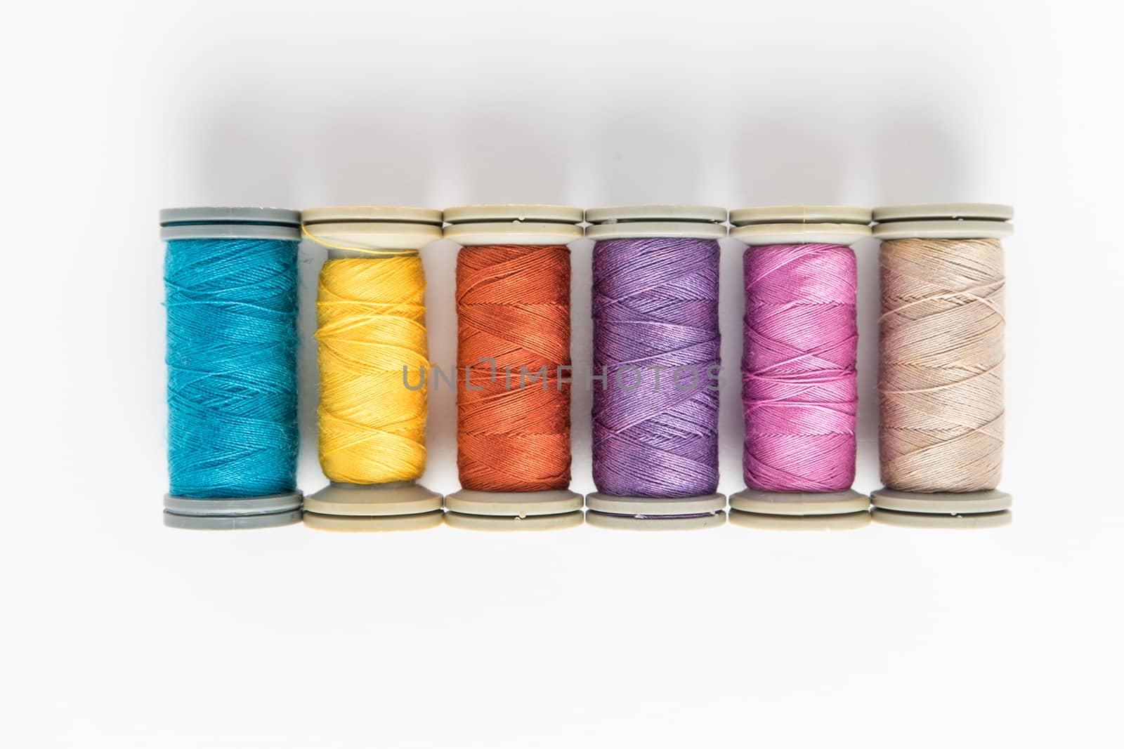 Multi-colored threads, sewing kit, a set of tailor on white background