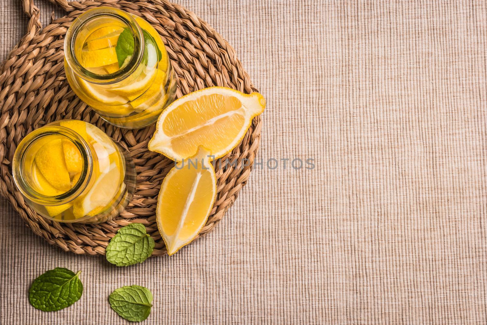 Slices and half fresh juicy lemon with mint leaves by AnaMarques