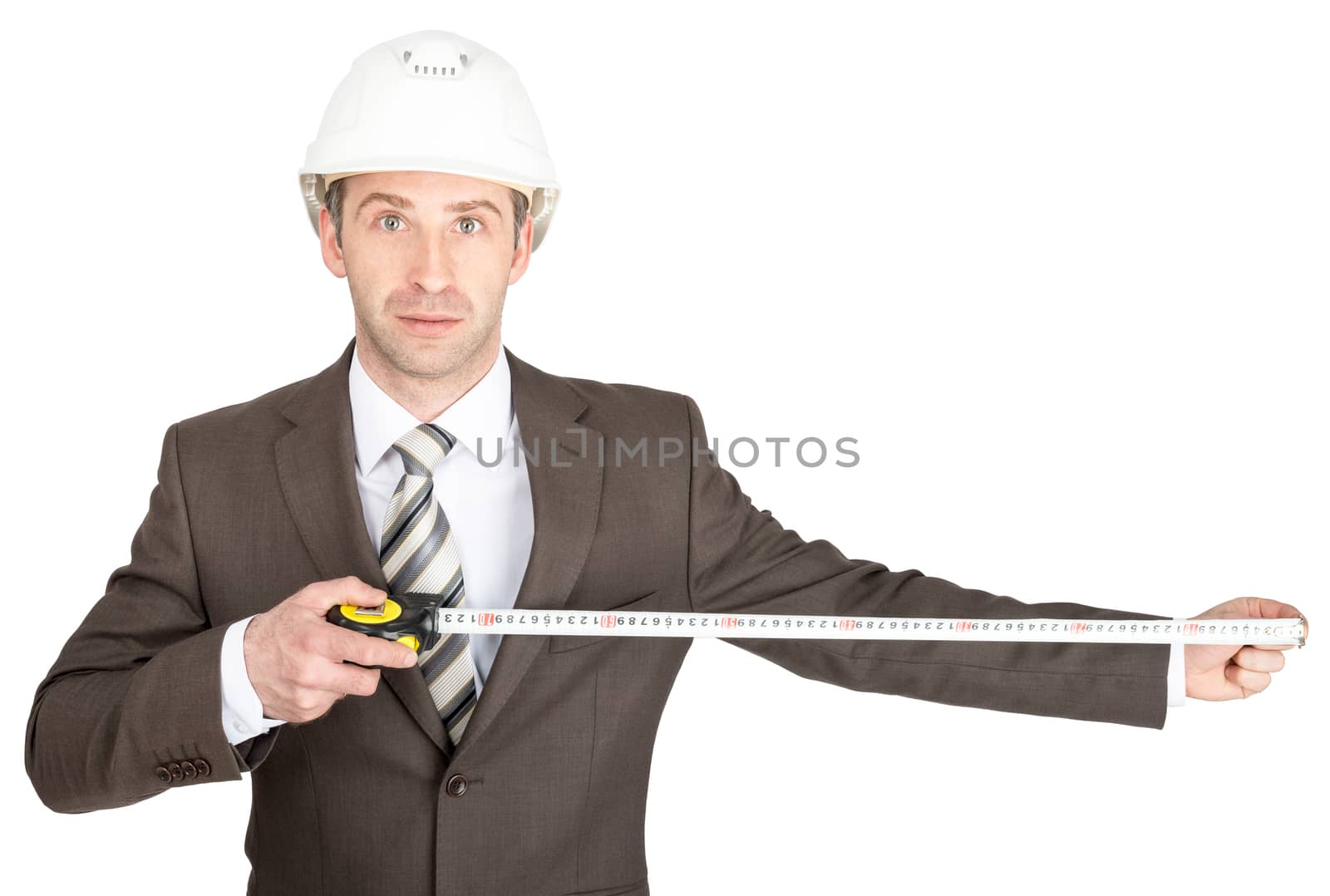 Businessman in suit and helmet holding measuring tape and looking at camera. White background