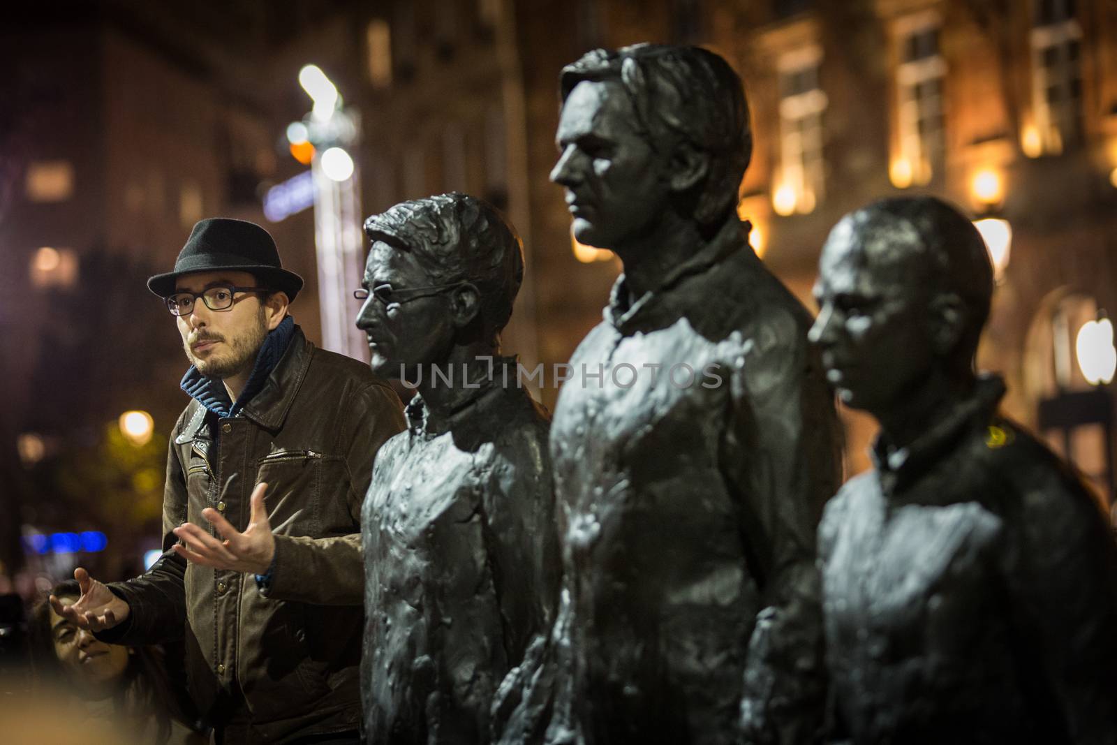 FRANCE, Strasbourg: Antoine Deltour stands on live size bronze sculpture Anything to say? of Italian artist Davide Dormino, portraying (2nd L-R) former National Security Agency (NSA) contractor and whistleblower Edward Snowden, WikiLeaks founder Julian Assange and former US soldier Chelsea Manning convicted of violations of the Espionage Act, in Strasbourg on November 17, 2015. The sculpture aims to be an interactive public art project for the freedom of speech. He and another former employees of accountancy giant PwC go on trial in Luxembourg on April 26, 2016 along with a French journalist, accused of leaking details of corporate tax deals that have fueled global demands for reform.