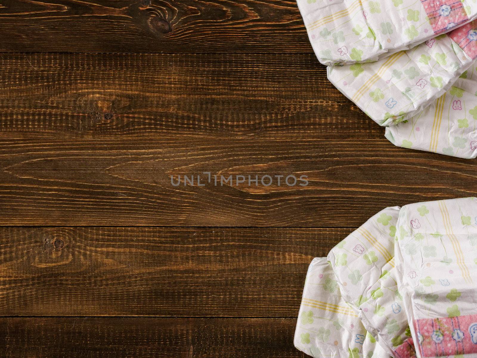 Japanese disposable diapers on dark wooden background with copy-space. Flat lay