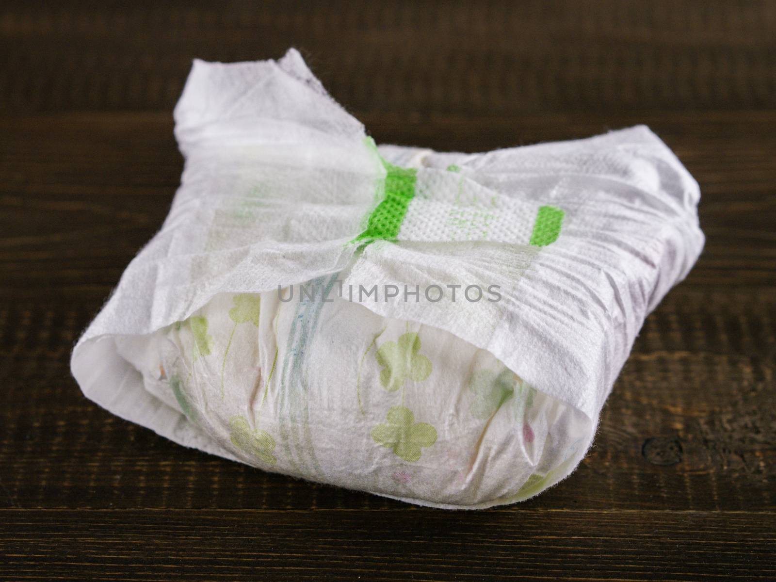 dirty diaper on dark wooden background, selective focus