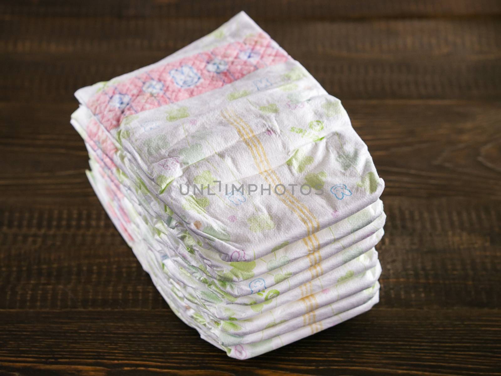 Stack of diapers on wooded background by fascinadora