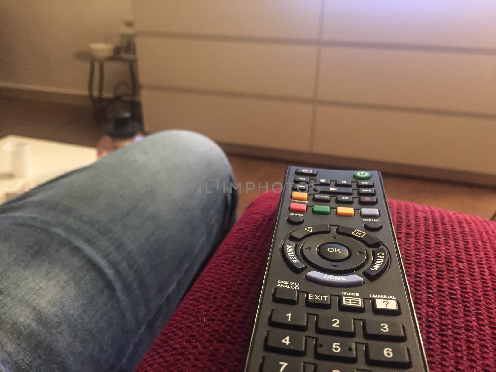 Black Remote control on a red couch
