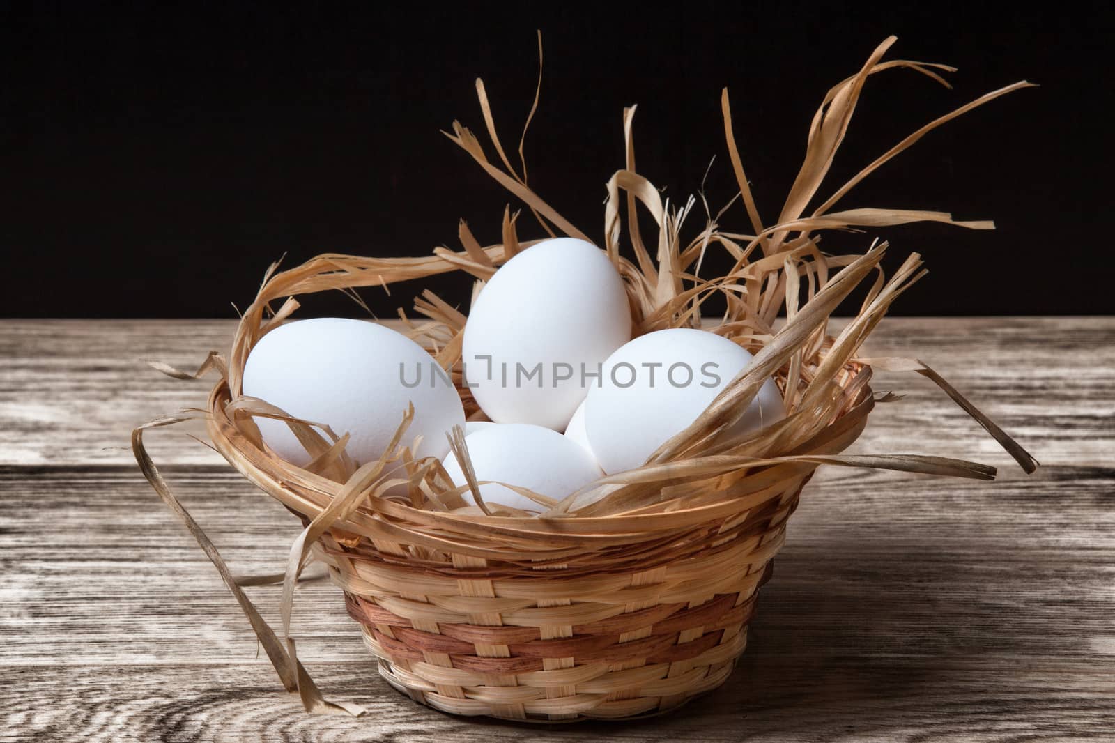 White chicken eggs in basket close up