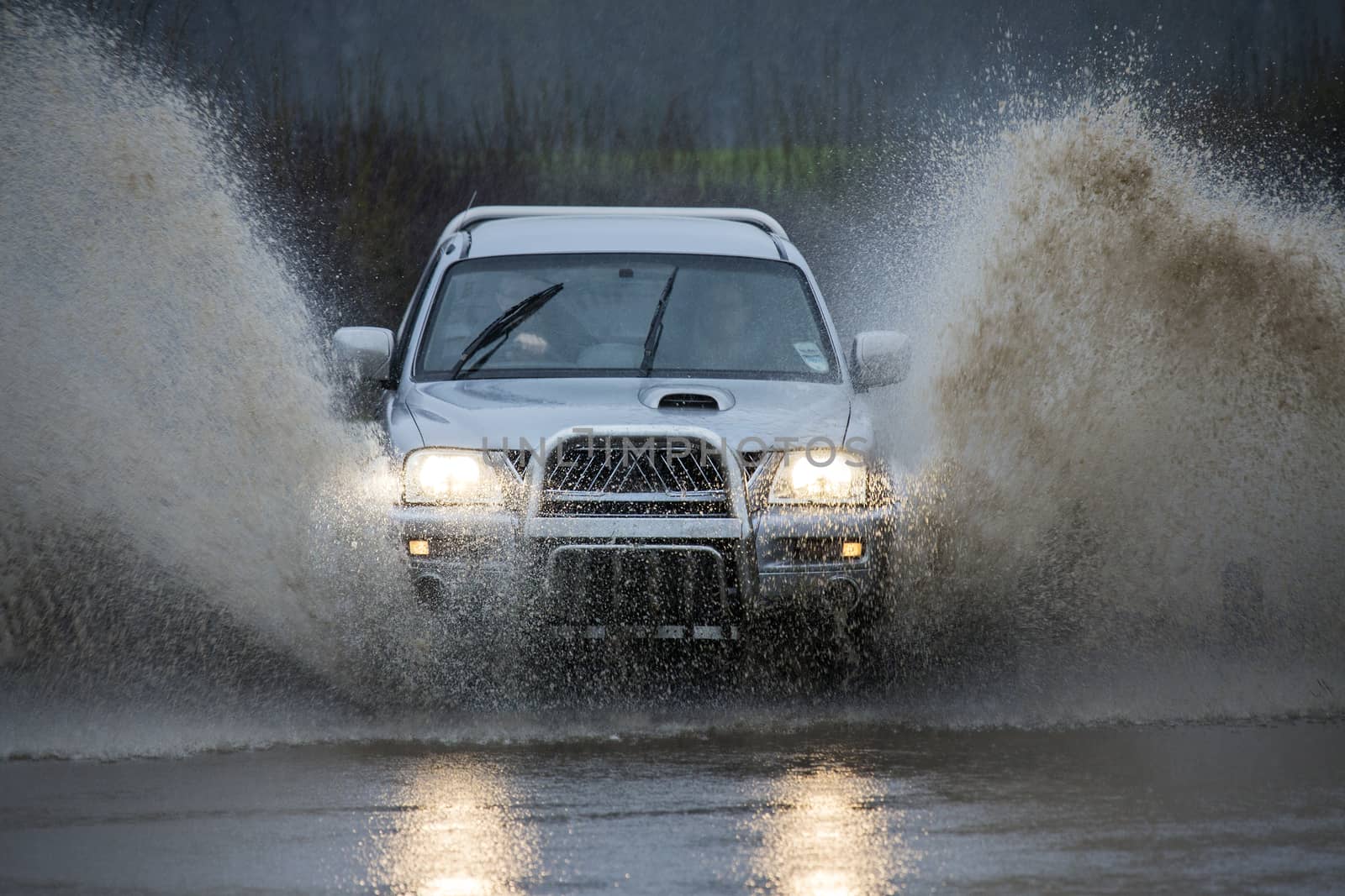 Driving through floodwater on a country road in North Yorkshire in the United Kingdom.