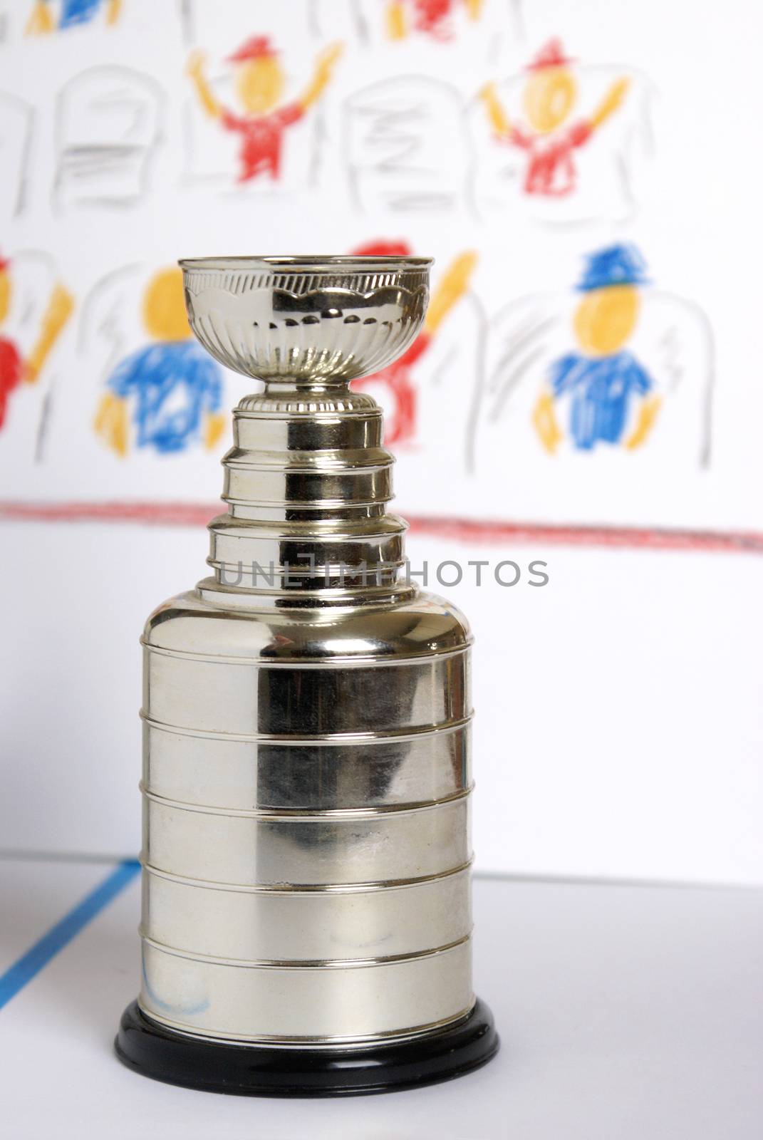 A closeup view of a replica Lord Stanley Hockey Trophy on a cartoon style backdrop.