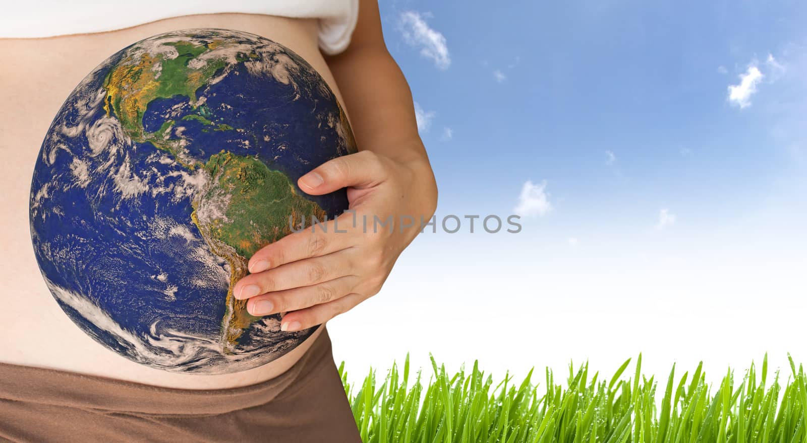 Belly with earth of pregnant woman - Elements of this image furnished by NASA
