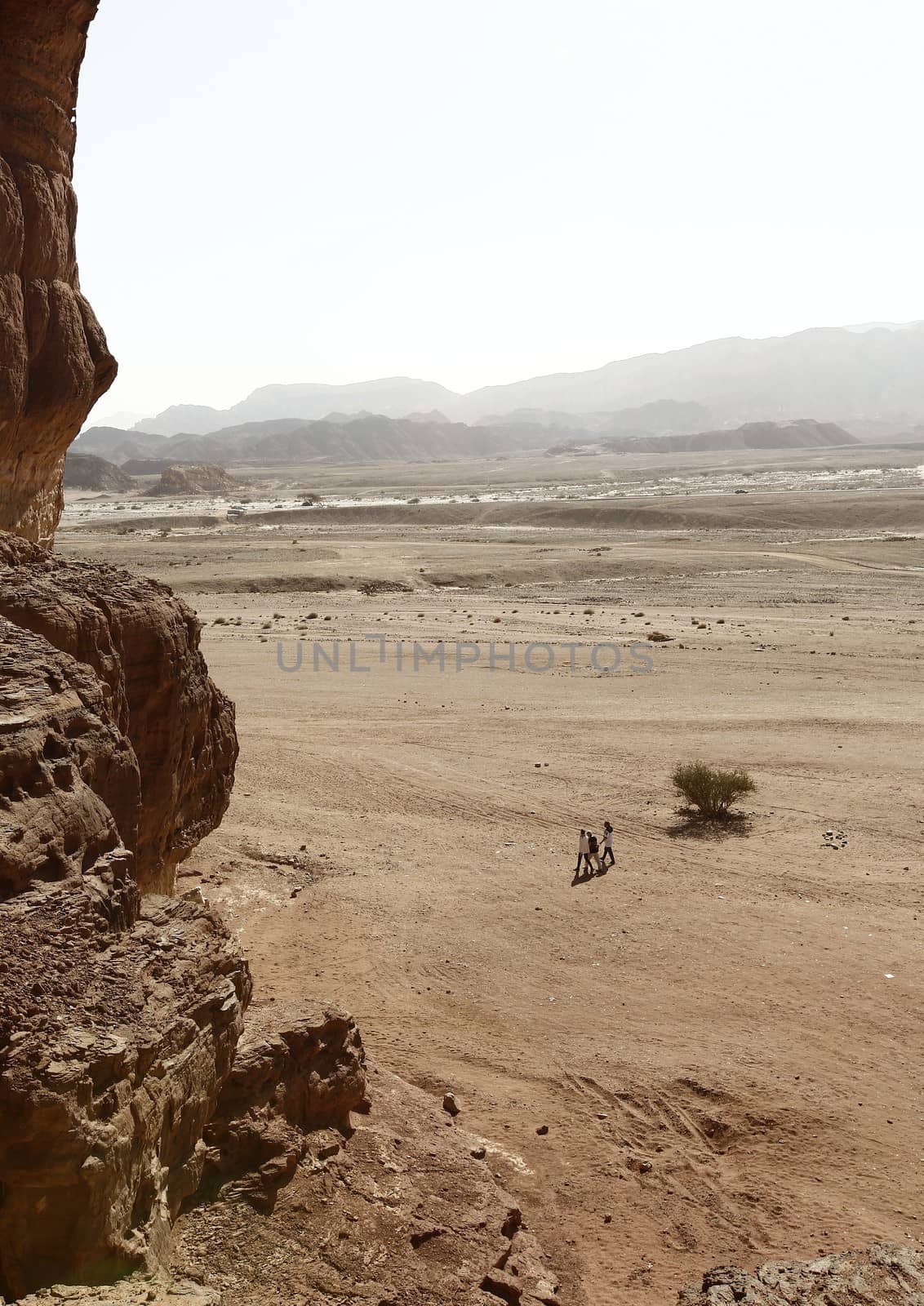 desert landscape, people walking along the canyon