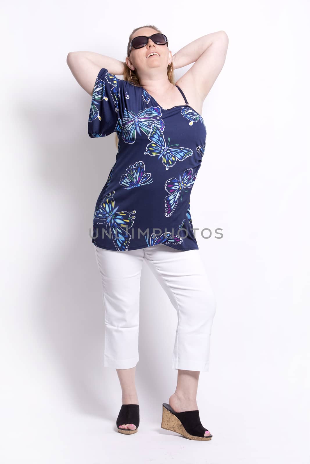 blond woman wearing summer outfit on white background