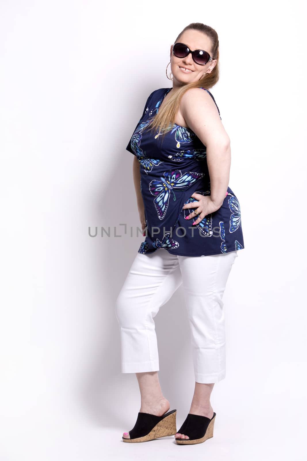 blond woman wearing summer outfit on white background