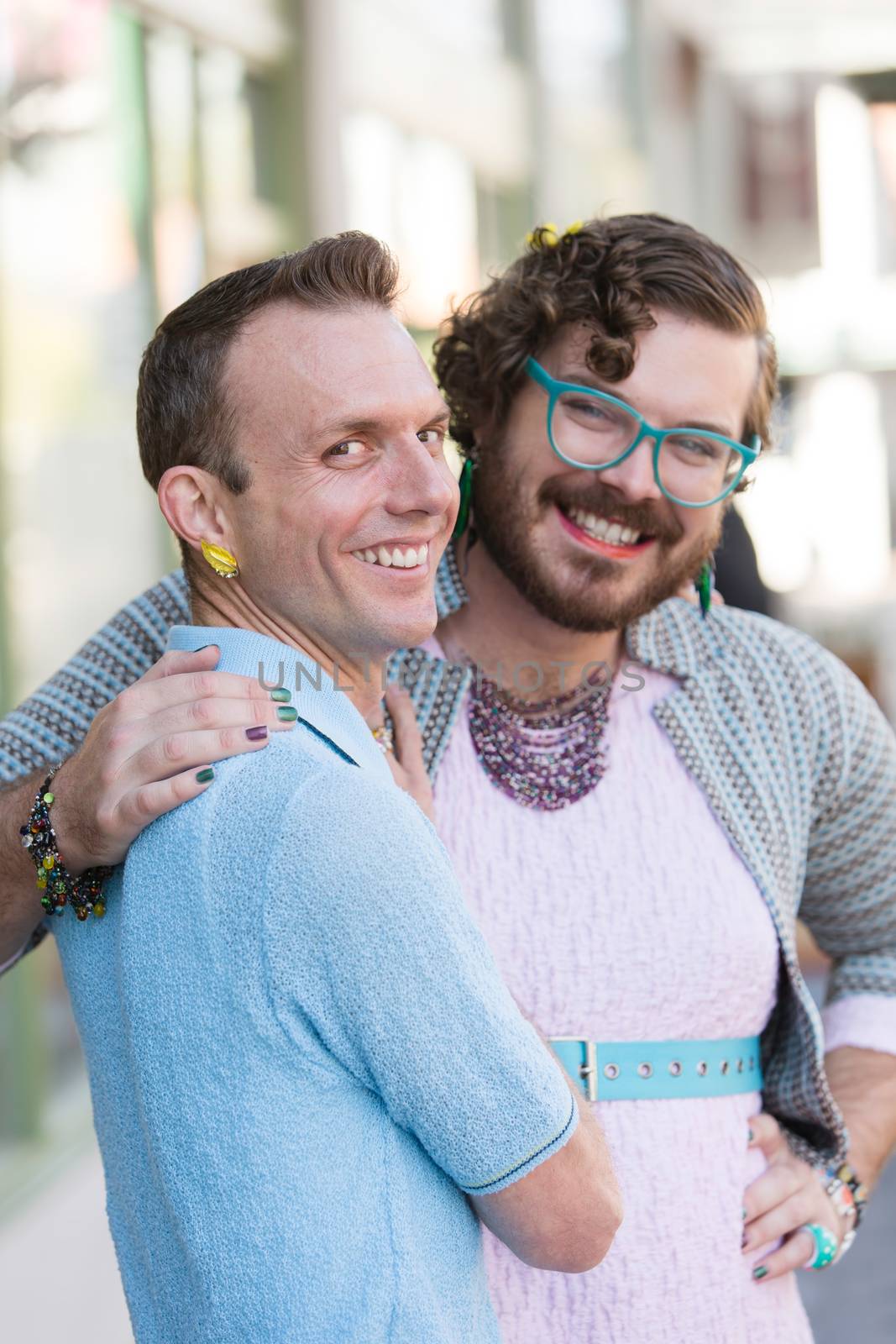 Gender fluid young male couple embracing on urban street