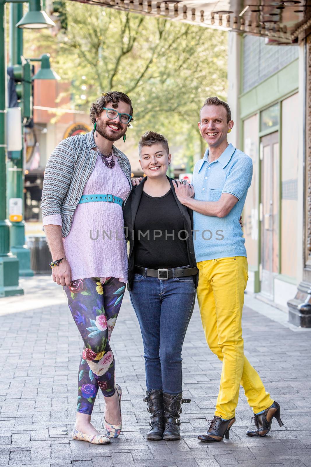 Three gender fluid friends on a city sidewalk