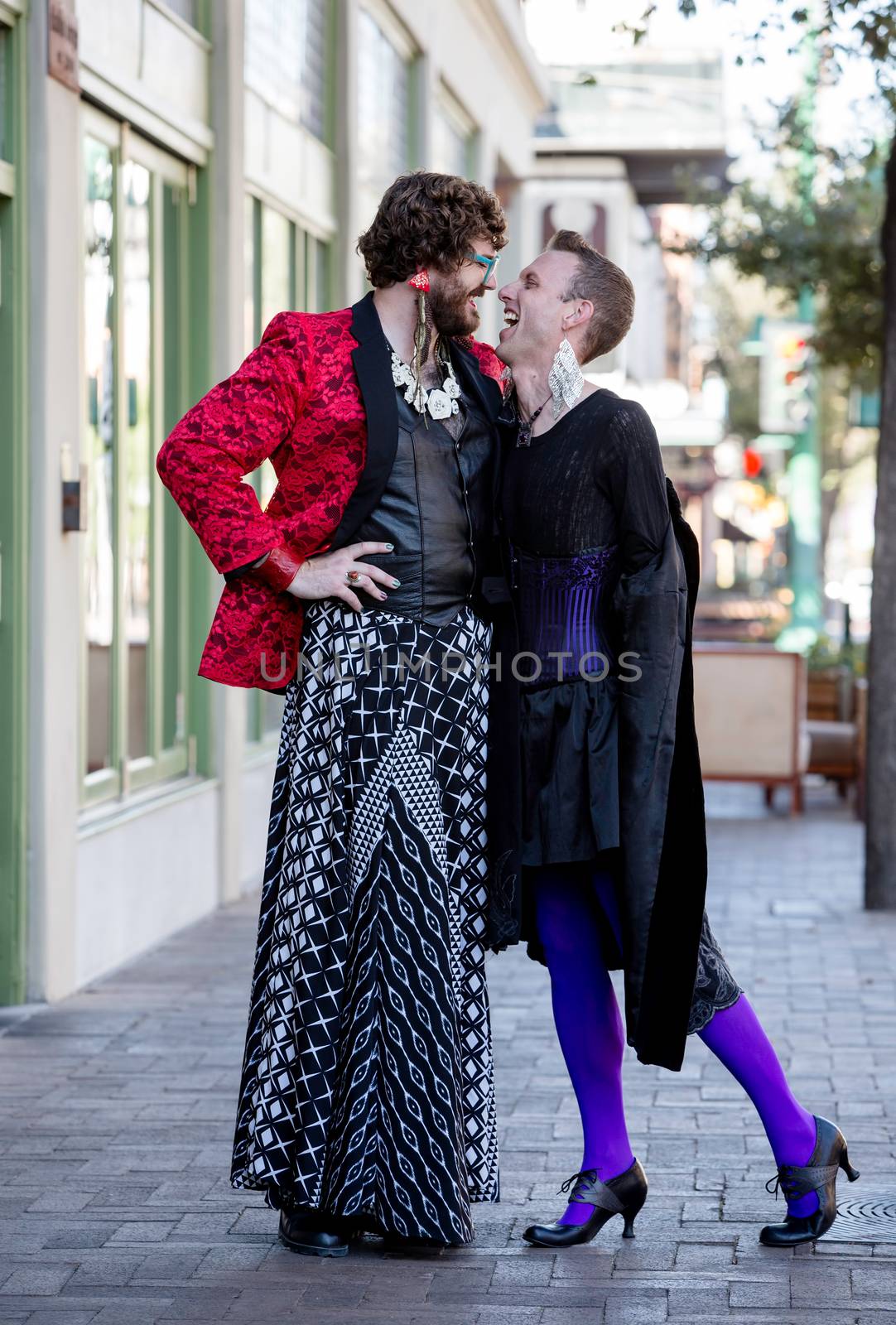 Handsome laughing gender fluid young men in flamboyant drag