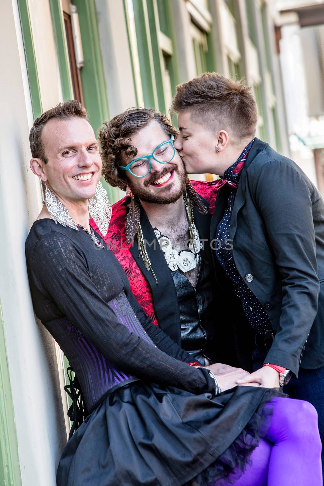 Friendly kiss in a young gender fluid trio