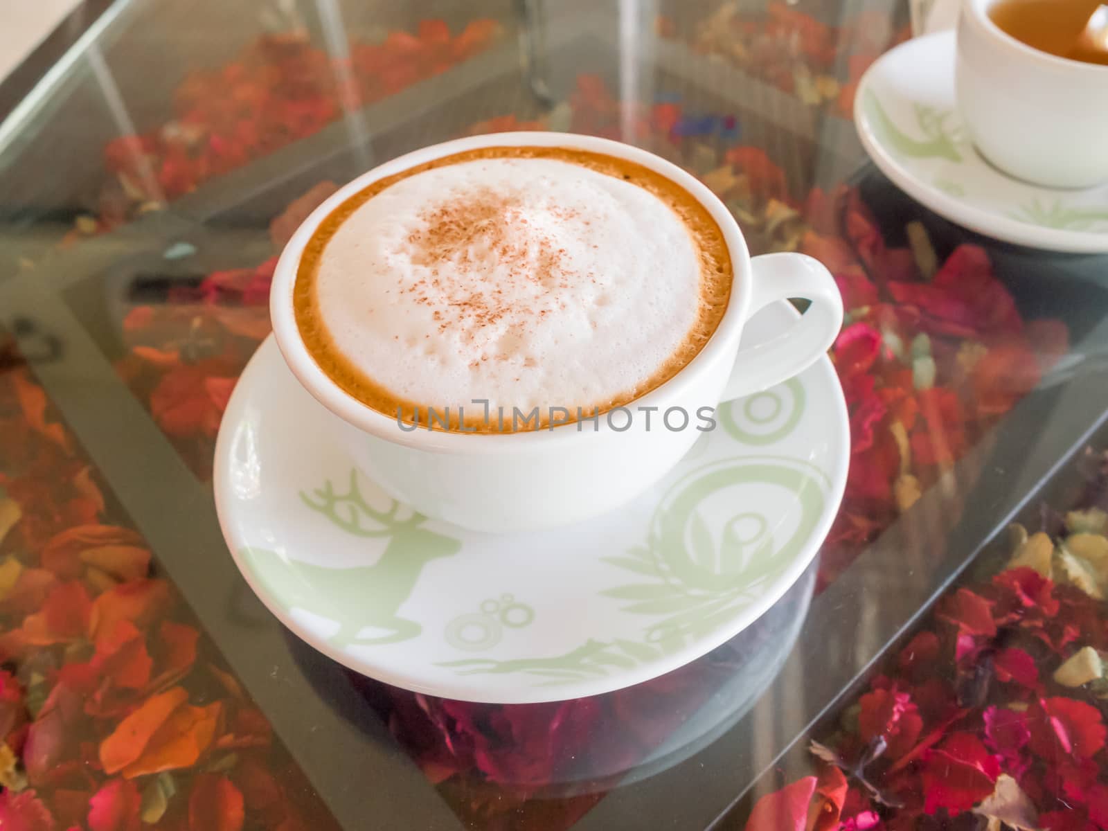 Close up white cup of Coffee, latte on the wooden glasses table