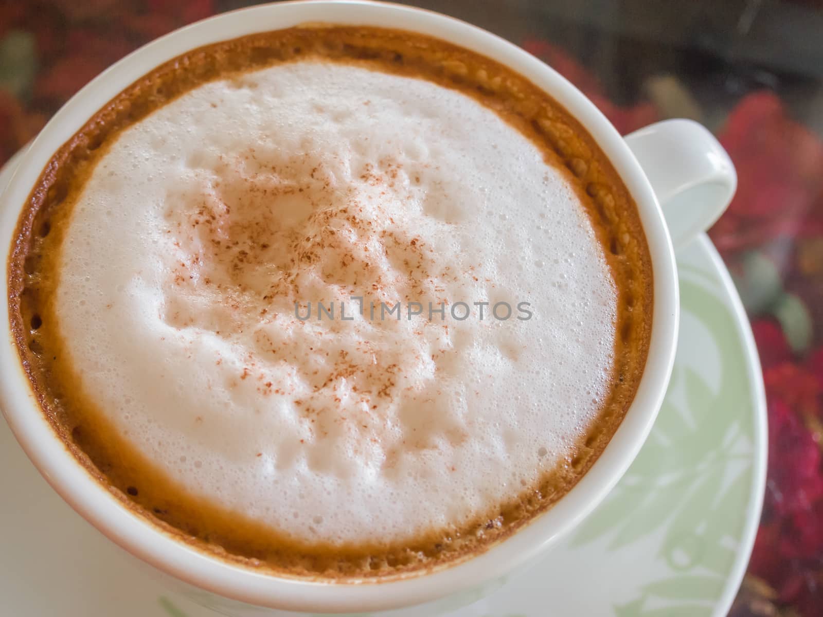 Close up white cup of Coffee, latte on the wooden glasses table