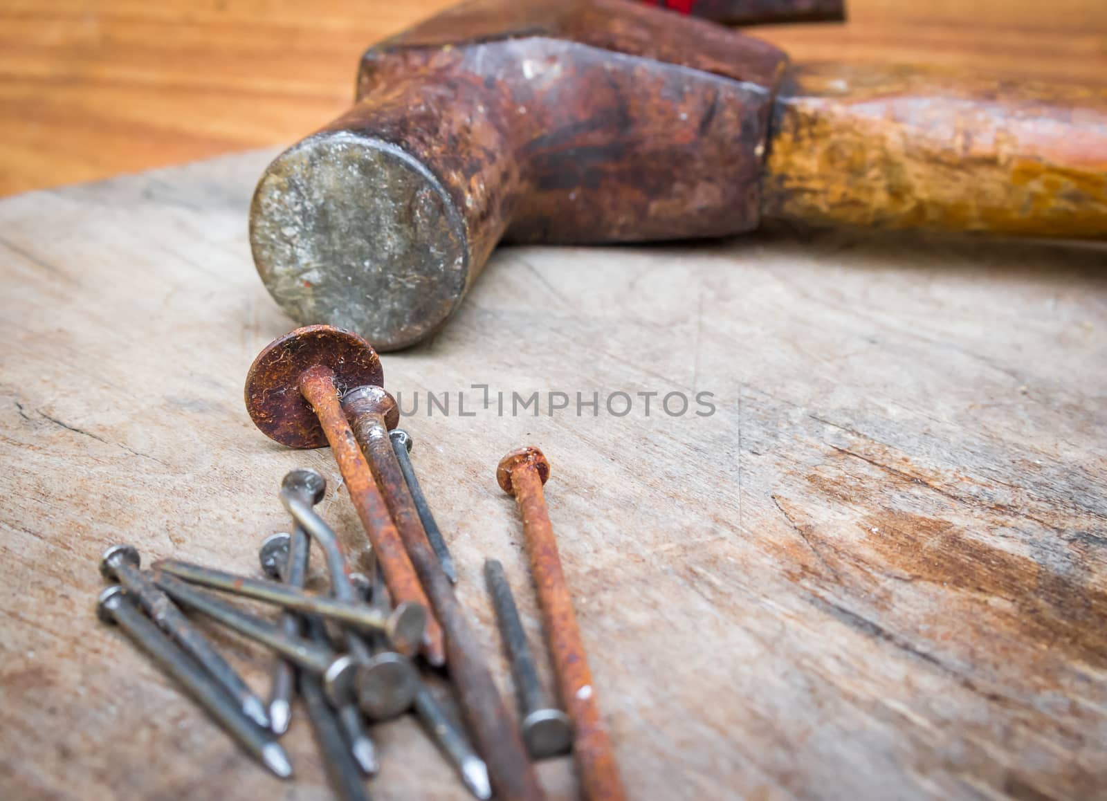 Old hammer and nails on the wood