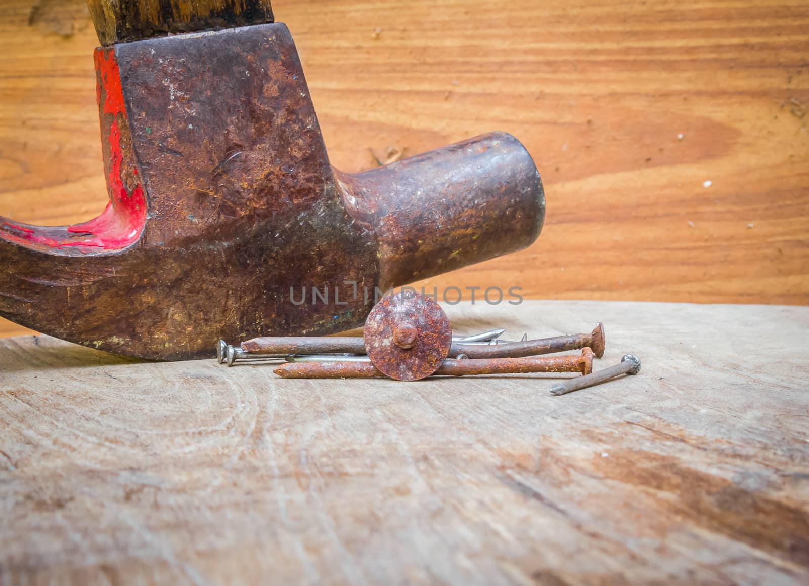 Old hammer and nails on the wood