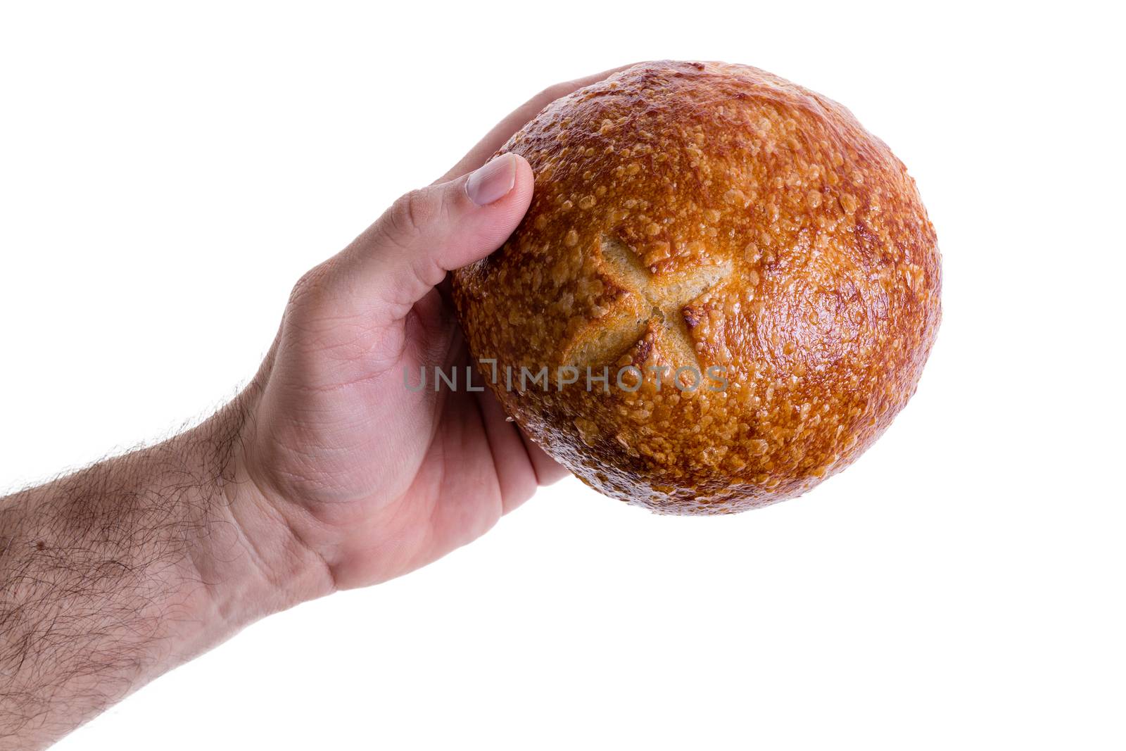 Male hand giving a sourdough bread roll by coskun