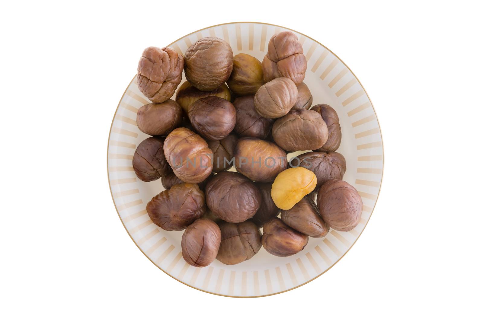 Fresh roasted peeled or shelled whole chestnuts on a plate for a delicious seasonal autumn snack, over a white background