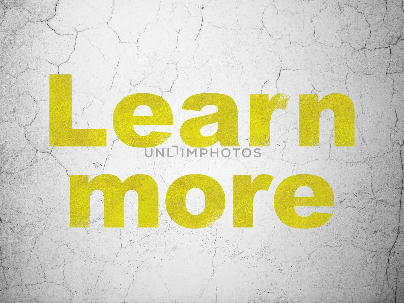 Learning concept: Yellow Learn More on textured concrete wall background