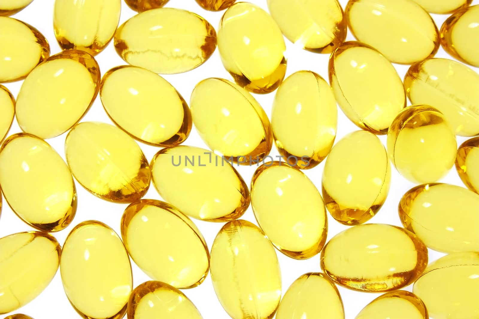 Healthy oil and vitamins capsule. Gel capsules background on white.