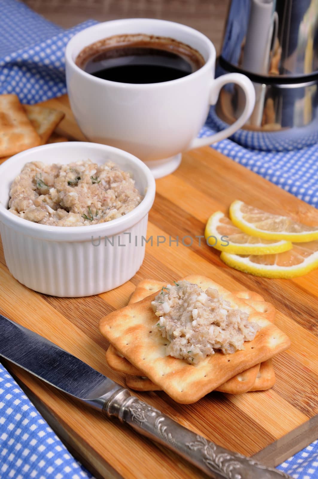 Snack  of fish paste (forshmak) on a cracker with a cup of coffee