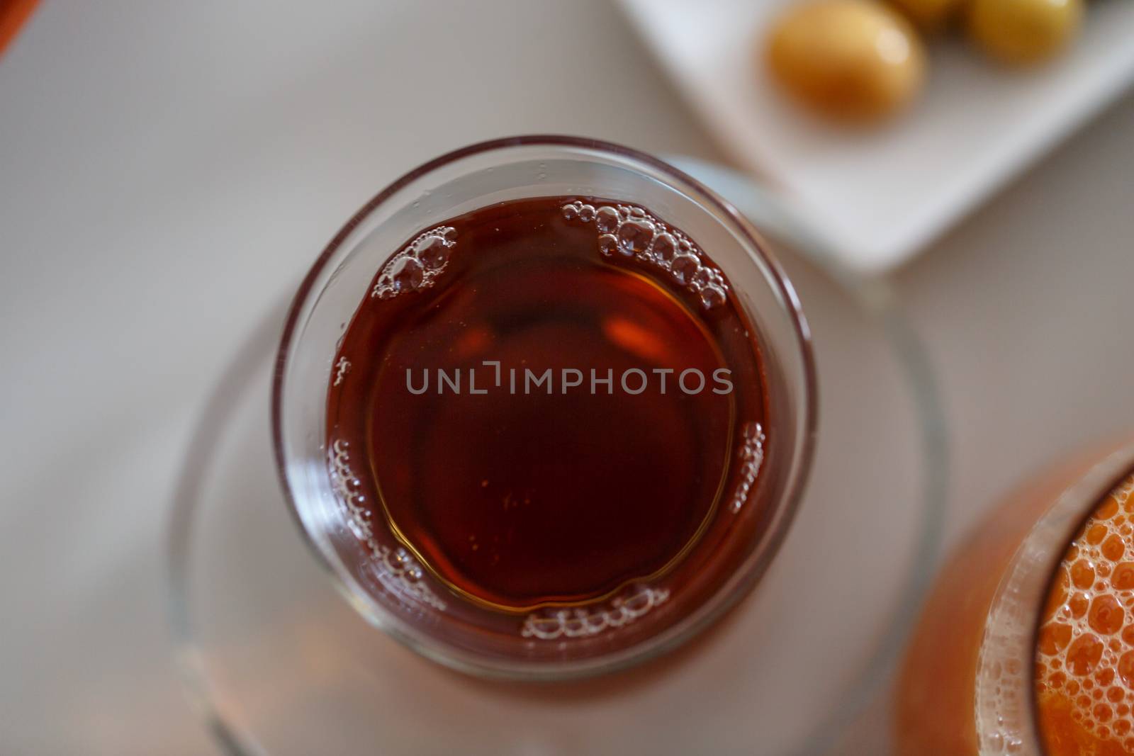 Close up detailed view of hot black tea in a glass.