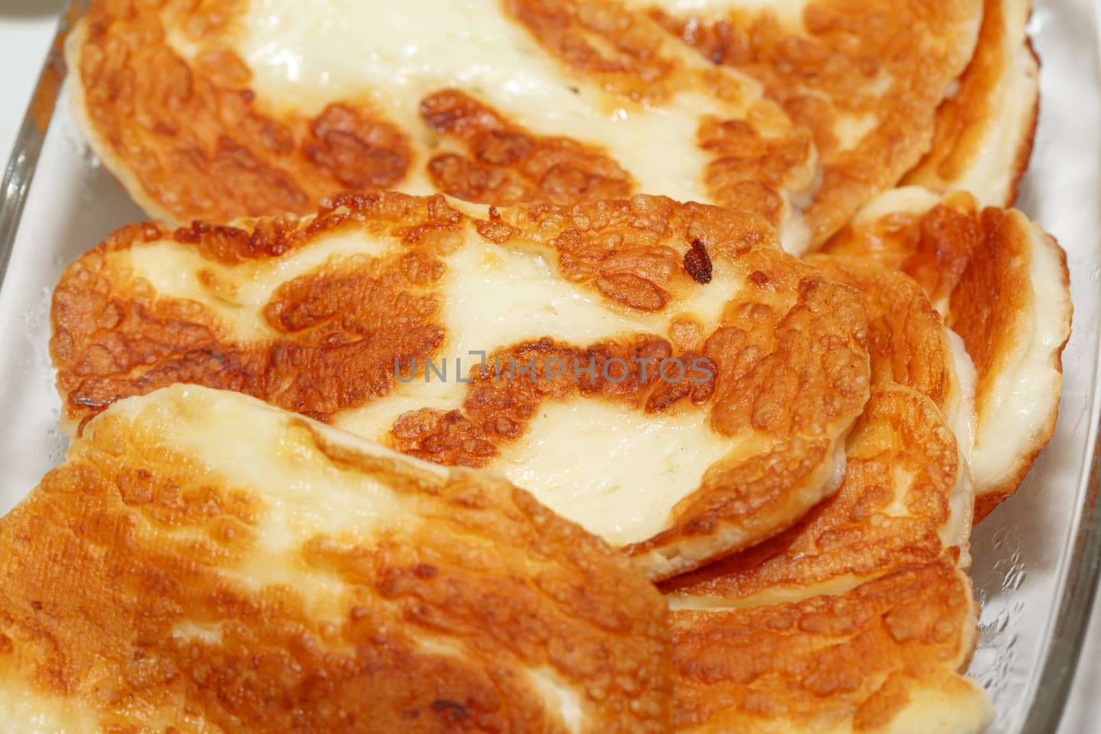 Close up detailed view of fried tasty helloumi cheese.