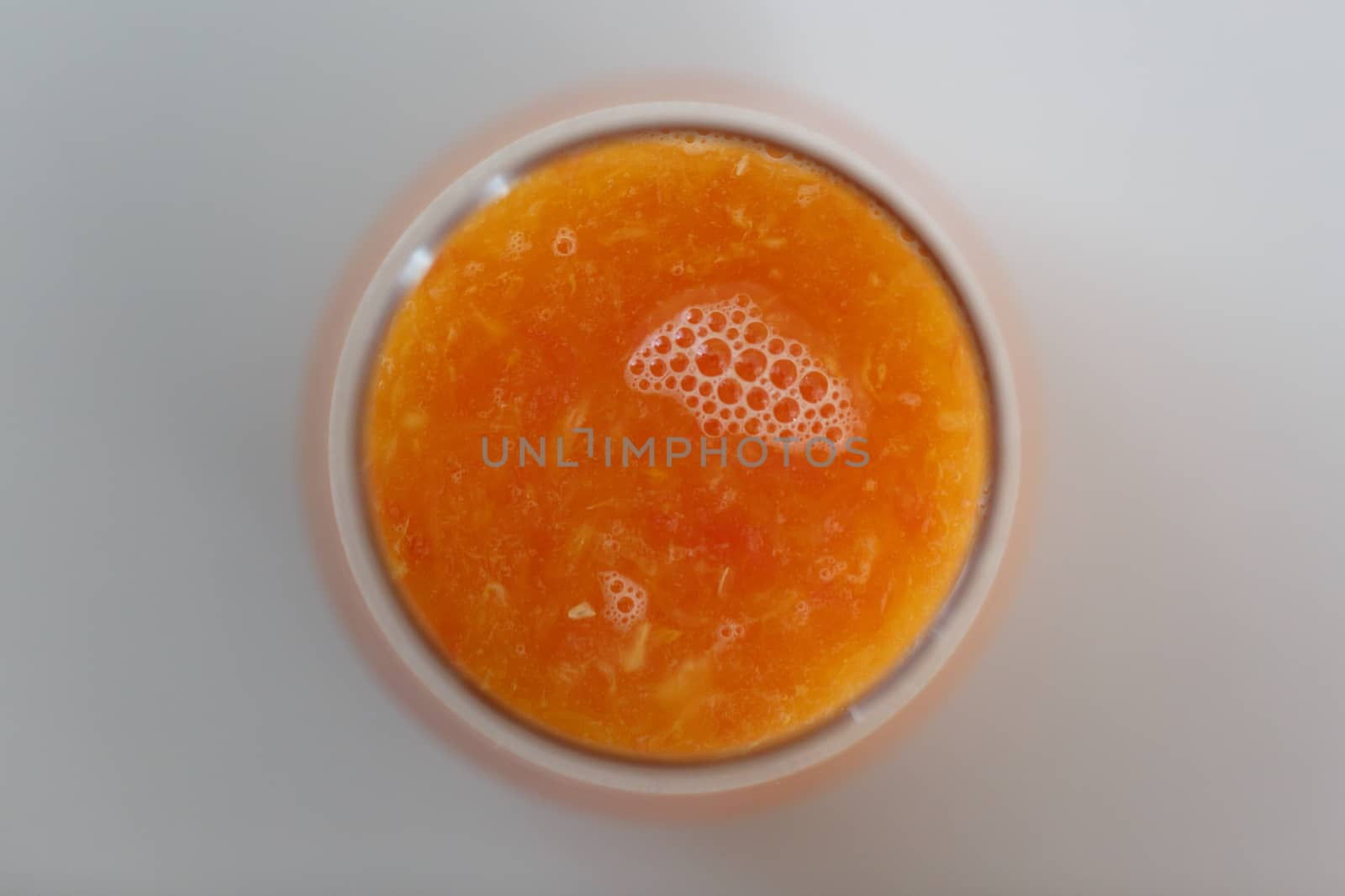Close up detailed top view of fresh orange juice in a glass