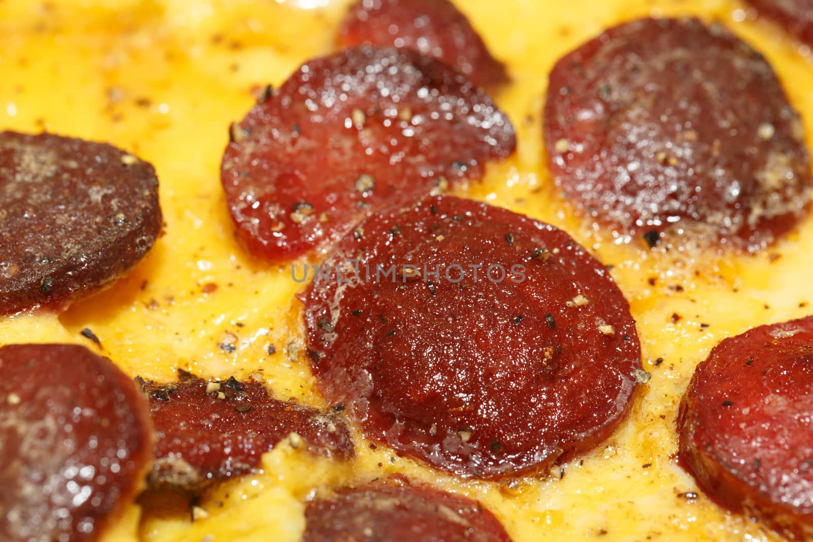 Close up detailed view of tasy omelette with sausage.