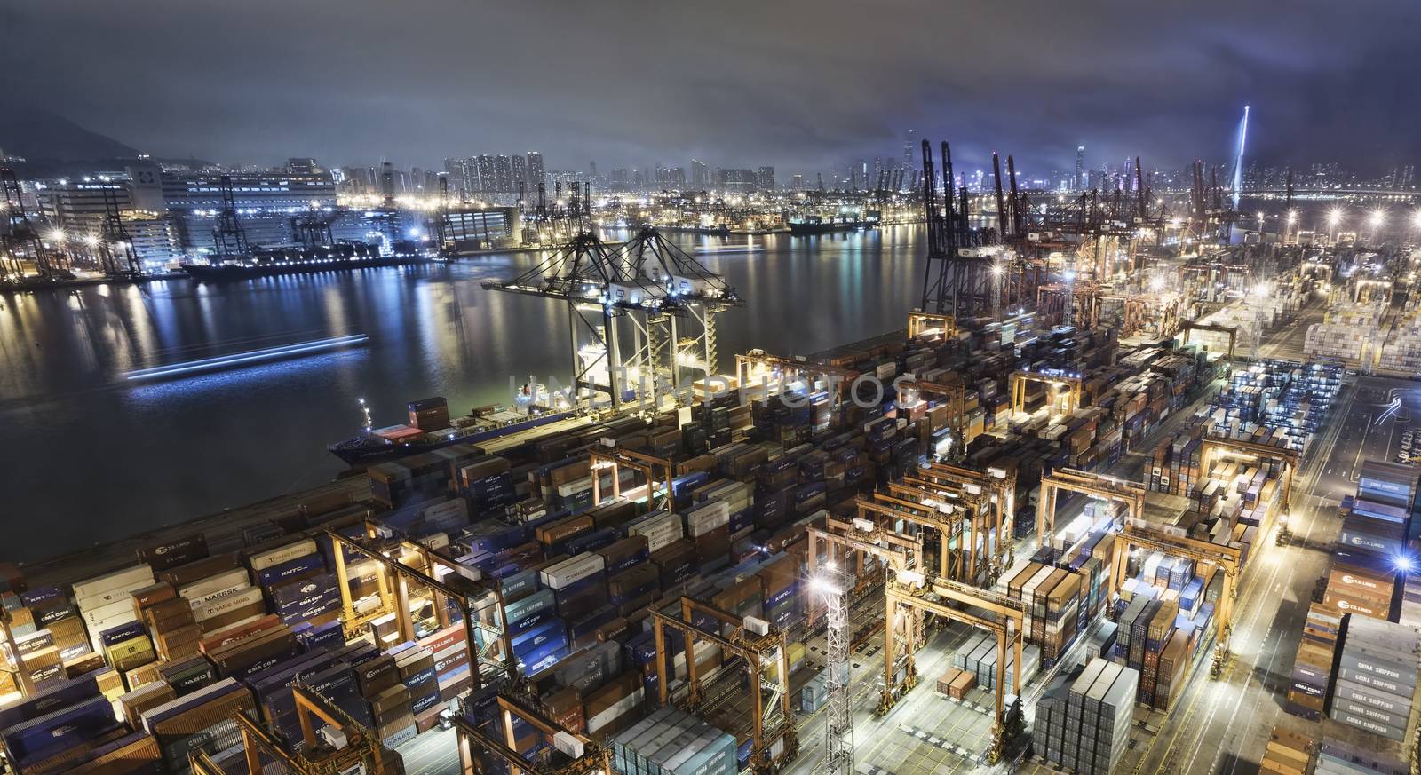 Cargo ship and crane at port reflect on sea bay, by cozyta