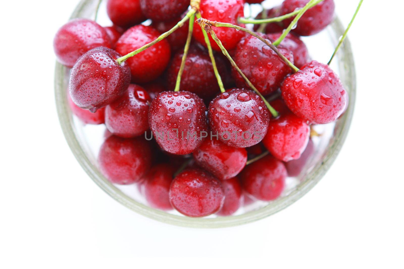 4804  Cherry red with drops in a glass bowl on a white background  - view from above