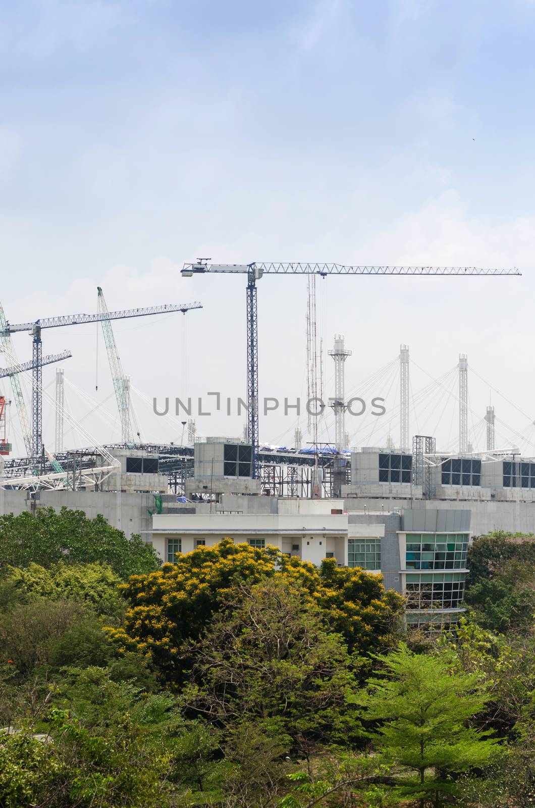 Mega construction site and mega cranes against blue sky
