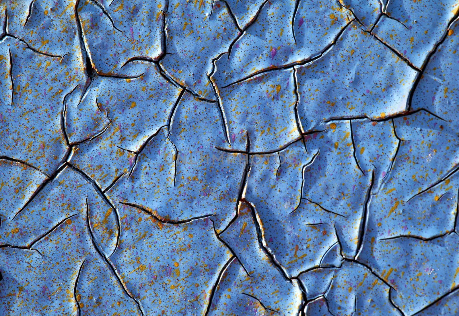 Close-up of peeling paint and rust on a wall
