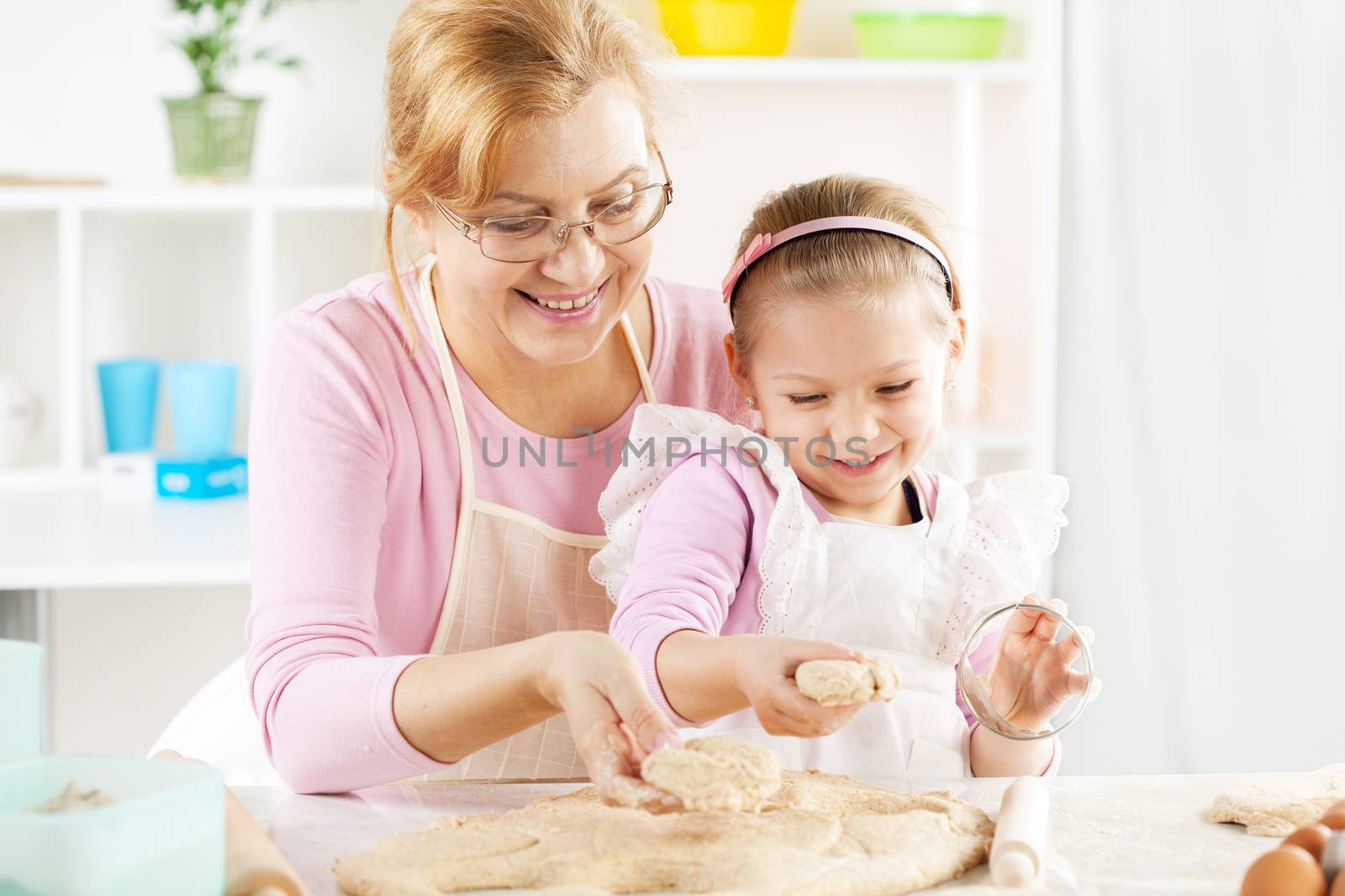 Grandmother and granddaughter making Dough by MilanMarkovic78