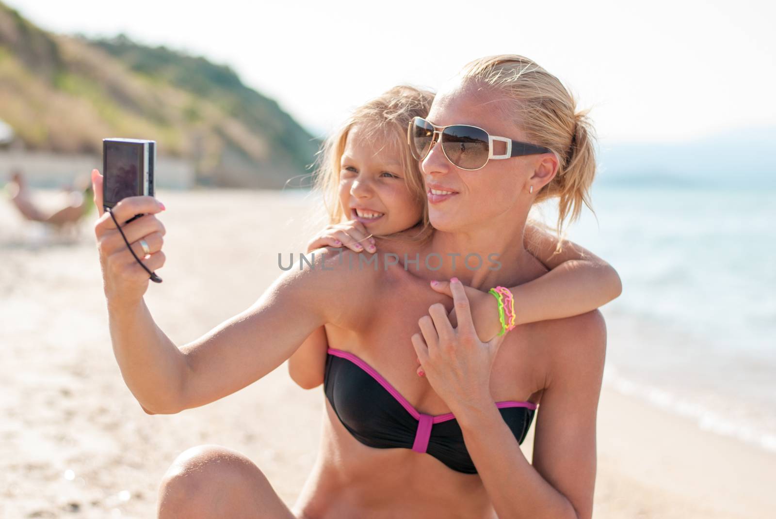 Mother and daughter selfie photographed at the beach