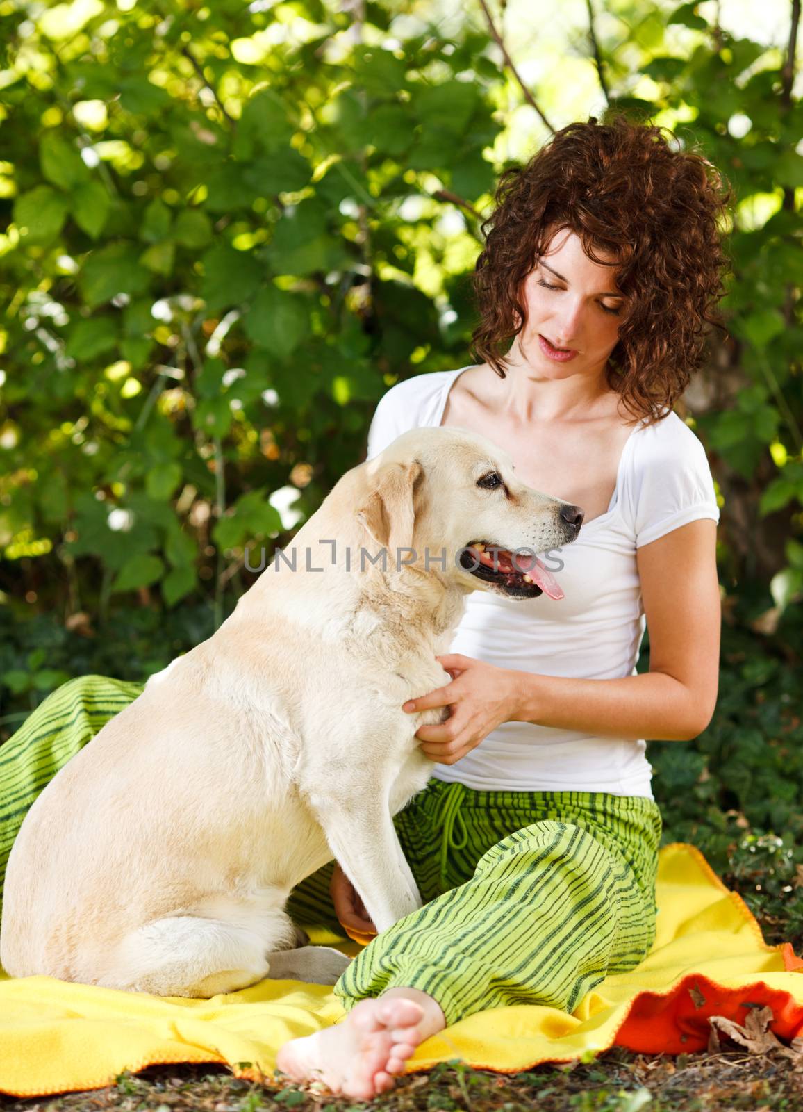 Beautiful young woman and dog in a forest