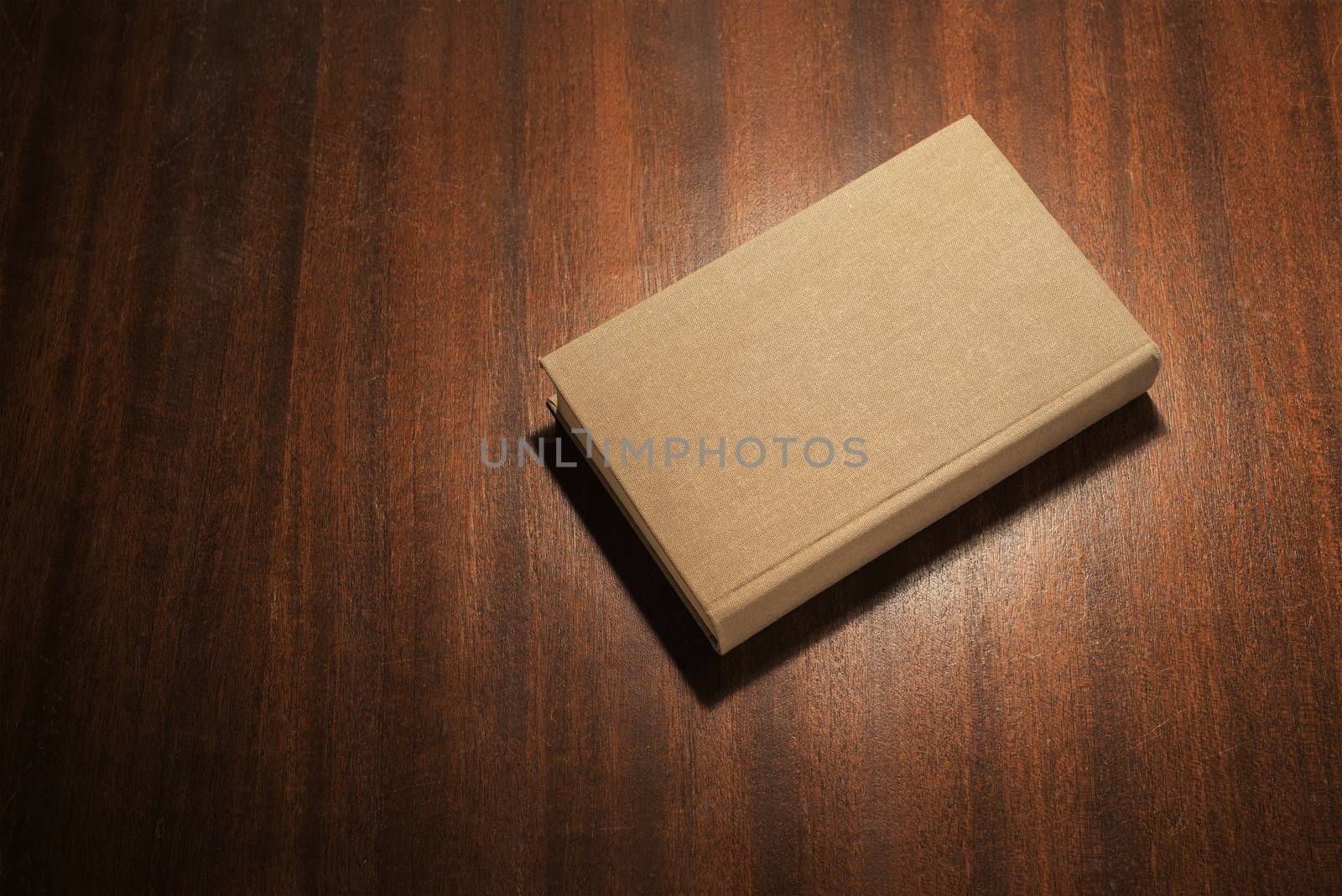 Grey book on the wooden scratched table