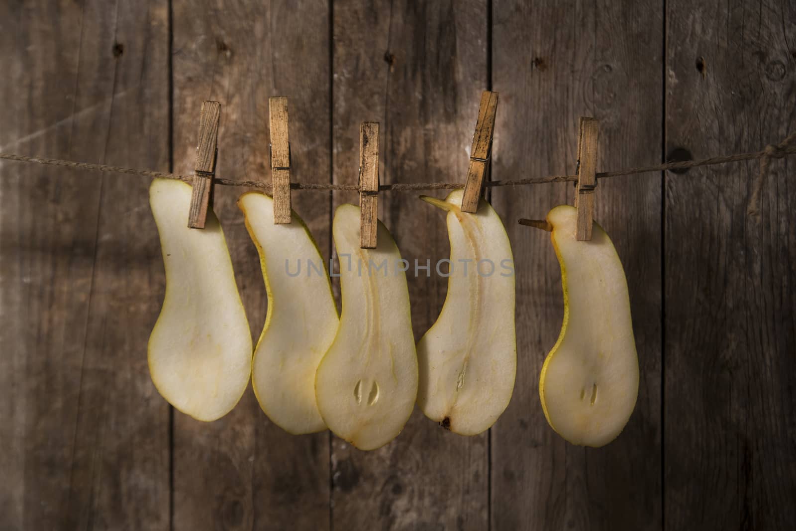 Pear slices williams hung with wire with tweezers