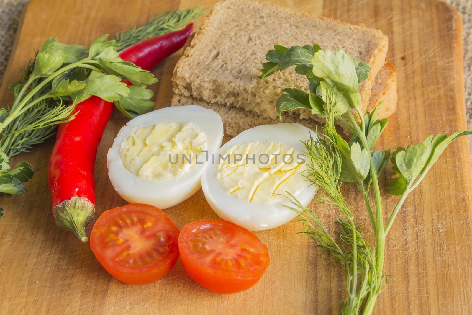 boiled egg, tomato, pepper on cutting board