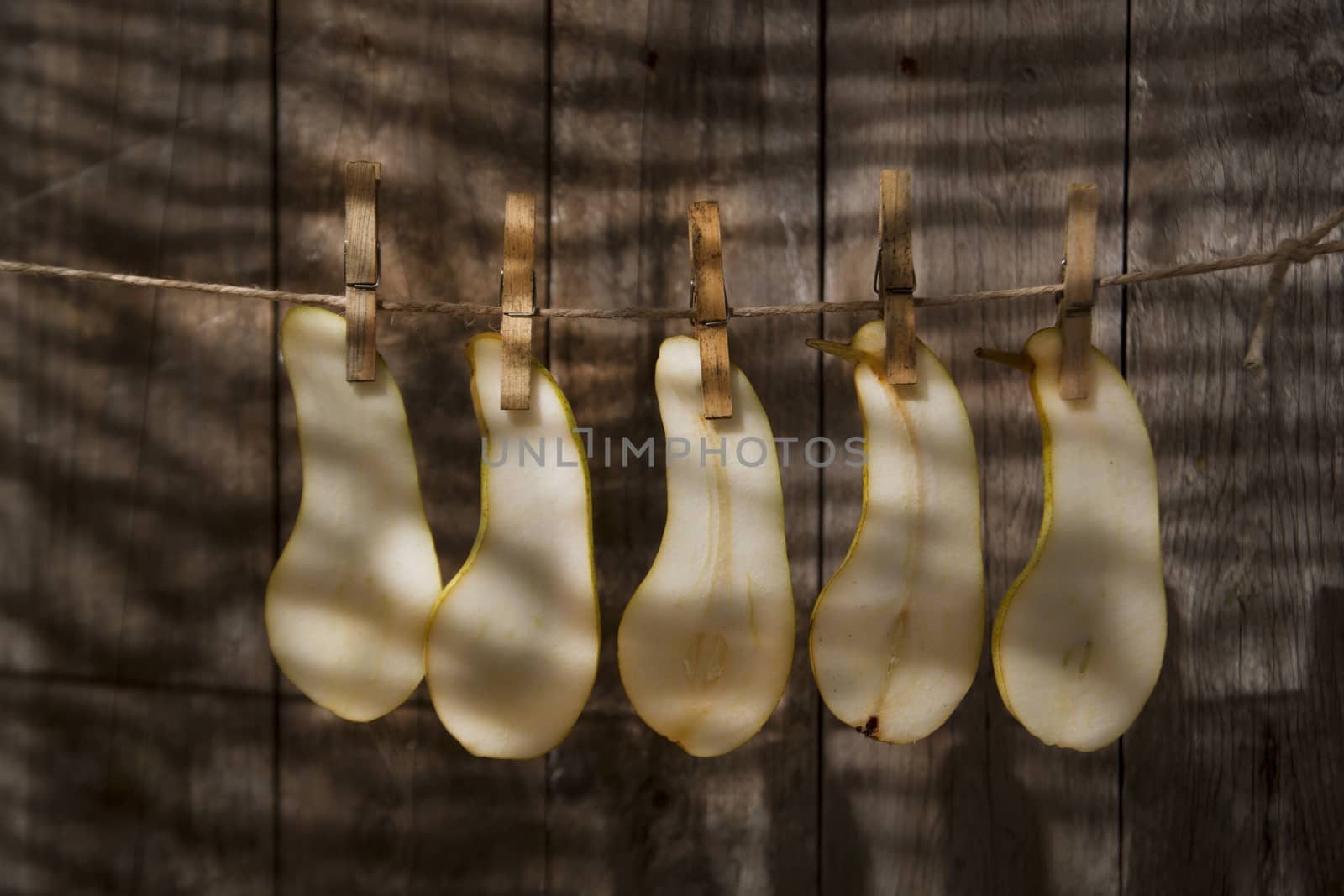 Pear slices williams hung with wire with tweezers