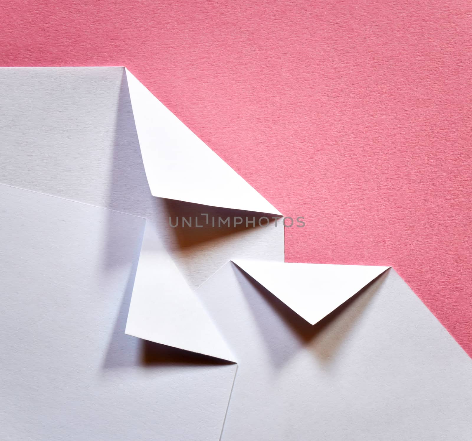 abstract white folded papers ticket on a pink background