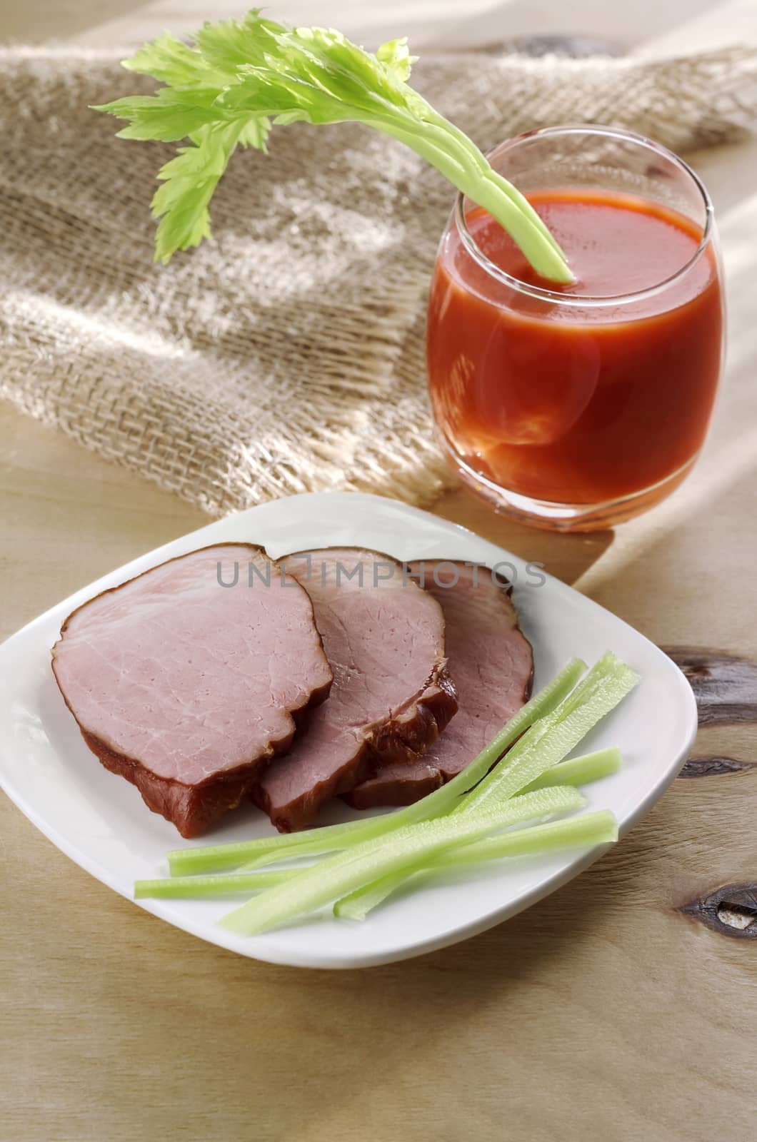 Meat on a plate and tomato juice in glass by Gaina