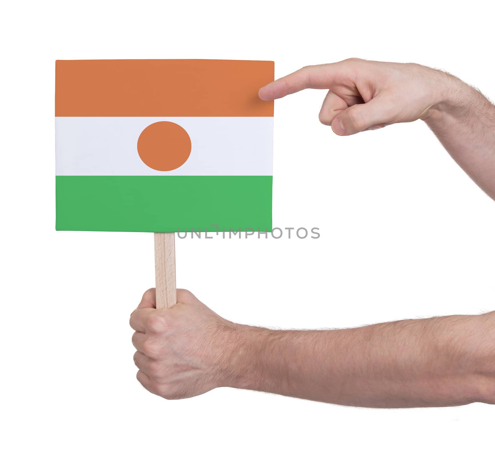 Hand holding small card, isolated on white - Flag of Niger