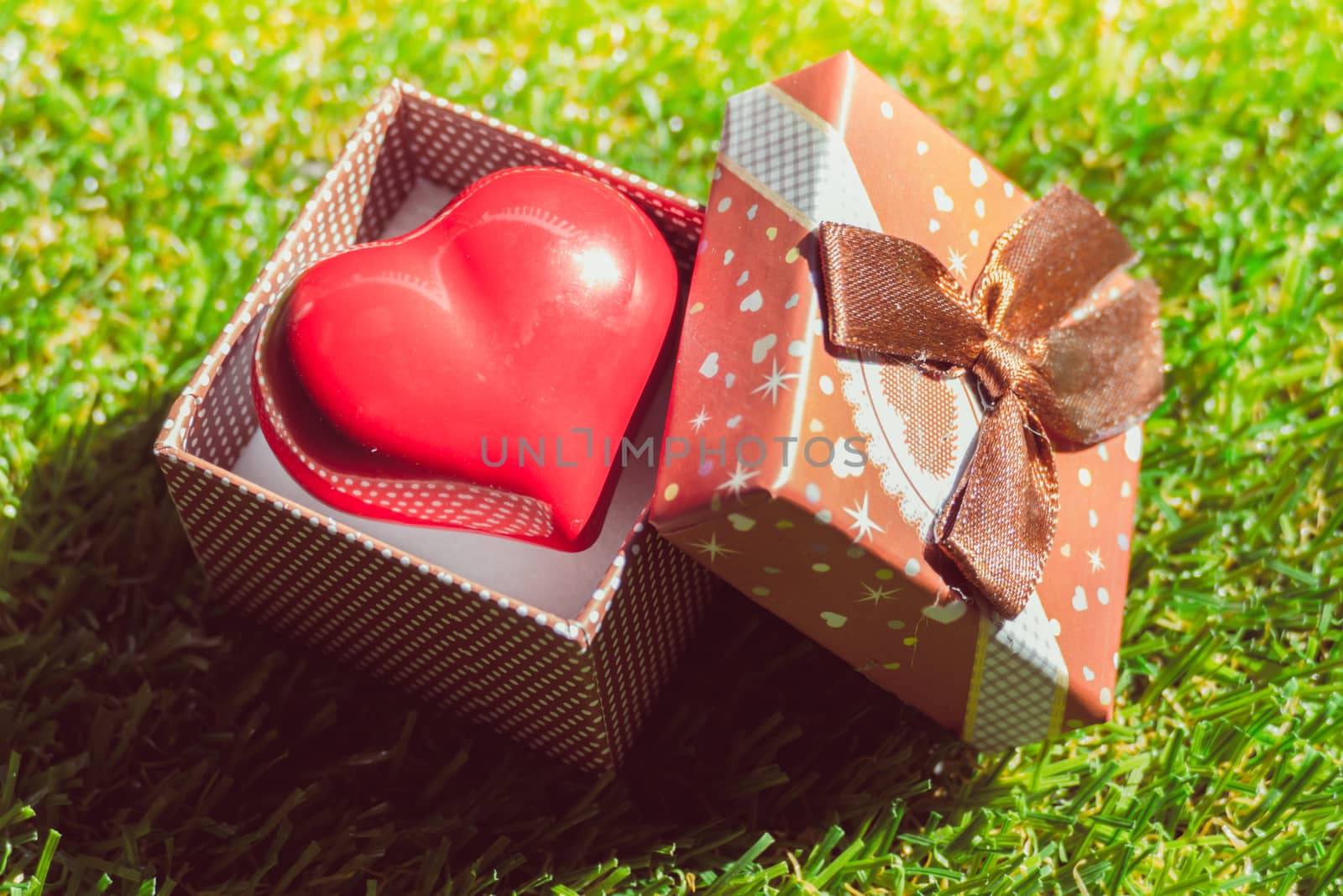 Gift of love. hearty gift. A gift box with a red heart inside. art background