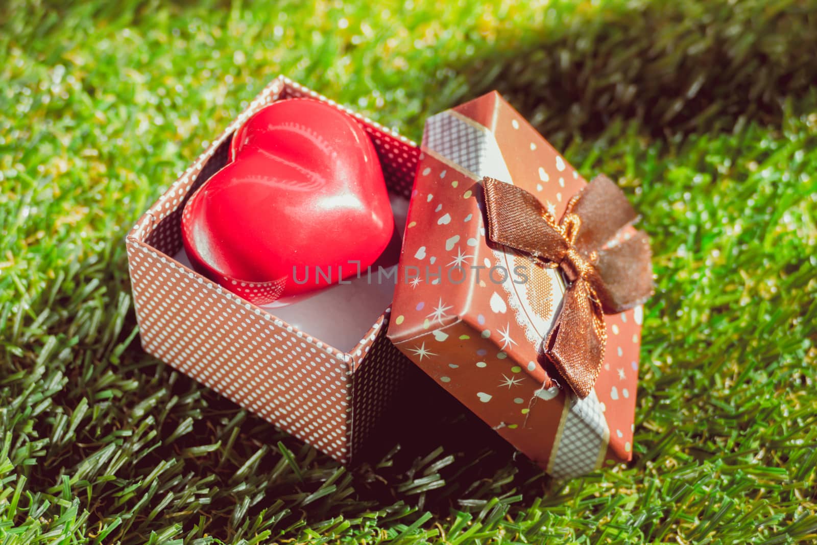 Gift of love. hearty gift. A gift box with a red heart inside. art background
