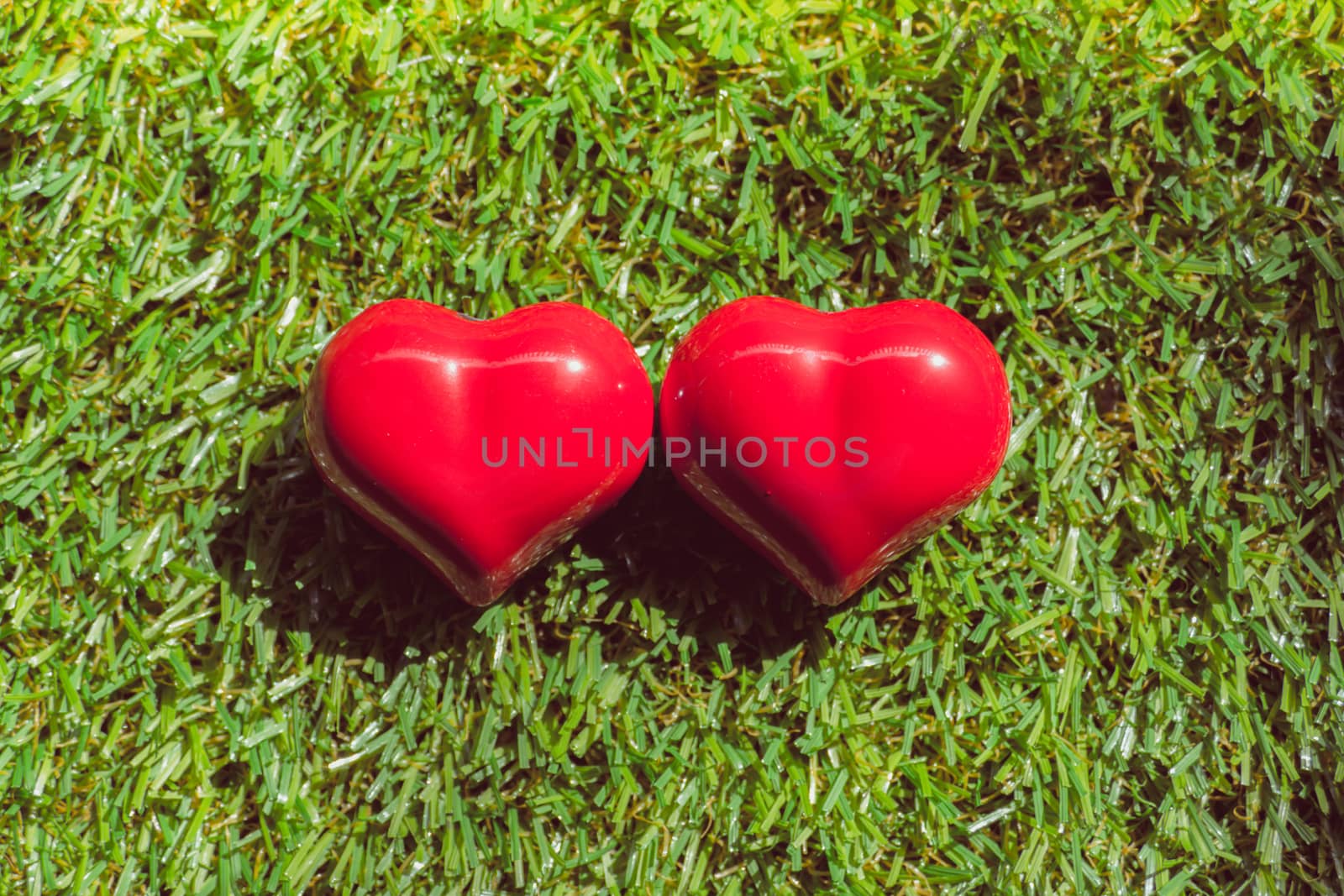 closeup of a red heart on the grass, art background